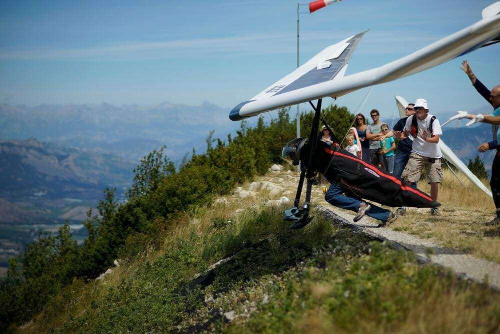 Hang gliding launch at Laragne-Montéglin with stunning alpine views and enthusiastic spectators.