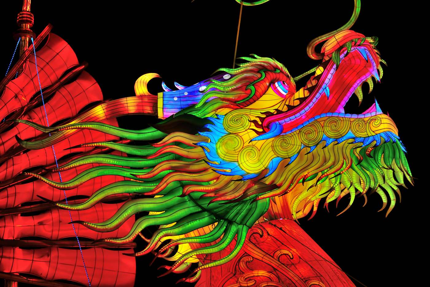 30617543 Colorful dragon lantern illuminated at night during a lantern festival, showcasing intricate designs.