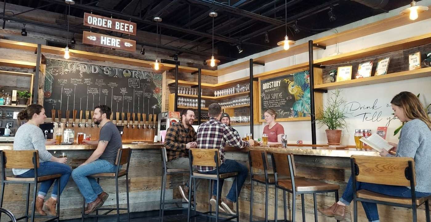 People drinking beer at Oddstory Brewing Co.